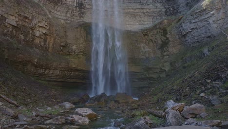 Majestic-waterfall-cascading-into-a-serene-rocky-landscape