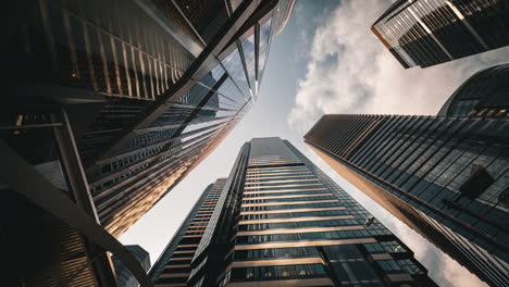 Modern-business-architecture-with-glass-and-steel-walls-reflecting-sky-clouds