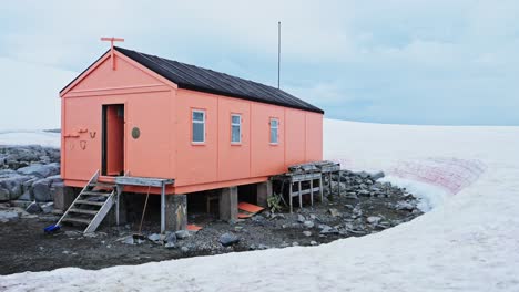 Antarctic-Hut-in-Antarctica-at-Damoy-Point,-Old-Shelter-Building-Surrounded-by-Snow-and-Ice-and-Icy-Winter-Landscape-Scenery-on-the-Antarctic-Peninsula