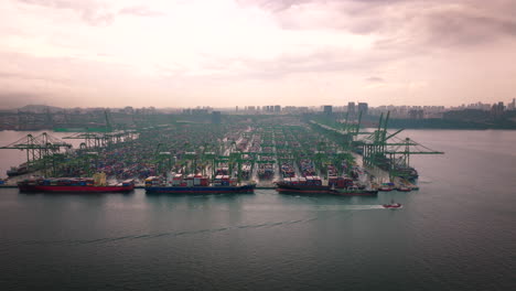 Sunset-aerial-view-over-Port-of-Singapore-with-containers-ships-and-cranes