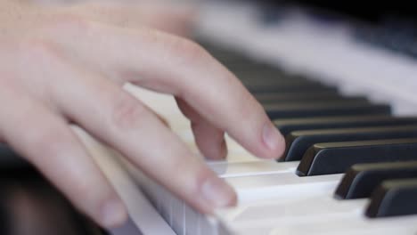 Close-Up-View-of-Male-Hands-Playing-Music-on-Keyboard-Piano-During-Recording-Session-with-Natural-Lighting-4K