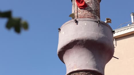 View-of-a-minaret-with-the-Turkish-flag-waving-in-Istanbul,-Turkey