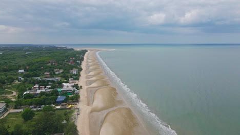 Cha-Am-Beach-in-Thailand-with-Beautiful-Surroundings-from-a-High-Aerial-Dolly-Drone-Shot