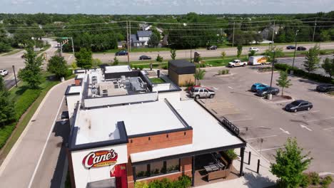 Aerial-dolly-to-Raising-Cane's-establishment-in-suburban-midwest-generic-town-on-sunny-day