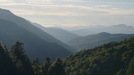 Forest-and-Himalayas-Mountains-Scenery,-Beautiful-Misty-Nepal-Landscape-with-Lush-Green-Trees-in-Himalayas-Foothills-in-Nepal-in-Beautiful-Mountain-Landscape-Scenery-with-Layers-of-Mist-and-Hills