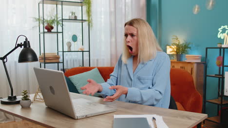 Displeased-businesswoman-using-laptop-surprised-bad-news-fortune-loss-game-fail-computer-virus-error