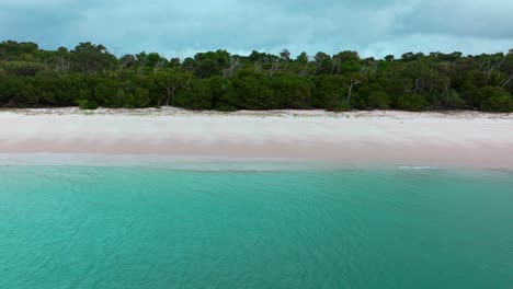 Serene-Whitehaven-Beach-white-sand-aerial-drone-Whitsundays-Island-Airlie-National-Park-Australia-AUS-QLD-rain-cloudy-blue-sky-outer-Great-Barrier-Reef-clear-blue-aqua-ocean-boat-yachts-static-shot