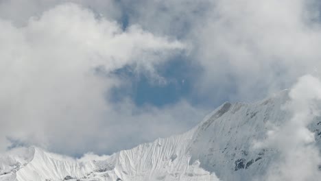 Snowcapped-Mountains-Close-Up-in-Clouds-in-Nepal,-Snowy-Himalayas-Mountains-Close-Up-Detail-Shot-of-Big-Mountain-Range-Ridge,-Dramatic-Mountains-Covered-in-Snow-in-Winter