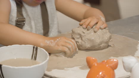 Hands-Of-Child-Playing-On-A-Mud-Clay