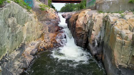 Aerial-drone-view-of-bottom-of-waterfall-pool,-Whitefish-Falls,-Manitoulin-Island,-Ontario,-Canada