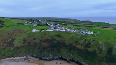 Nestled-on-edge-of-the-world,-Worm’s-Head-Village-sits,-timeless-location