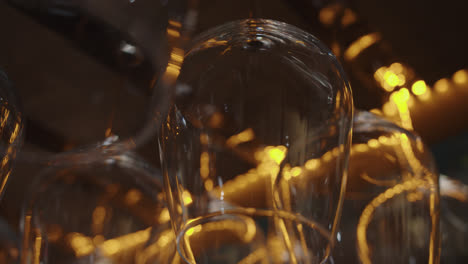 Beautiful-slow-motion-close-up-shot-of-a-set-of-wine-glasses-placed-upside-down-on-the-bar-top-of-a-bar-restaurant