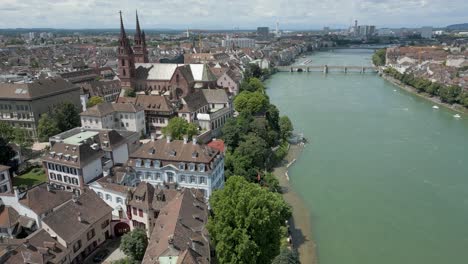 4K-Drone-Video-of-Gothic-Church-on-the-banks-of-the-Rhine-River-in-Downtown-Basel,-Switzerland