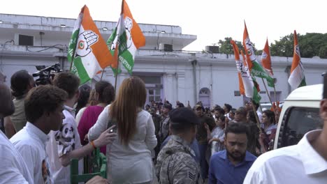 Congress-party-supporters-gathered-at-Congress-headquarters-to-show-support-for-Rahul-Gandhi,-Congress-political-party-flags-waving