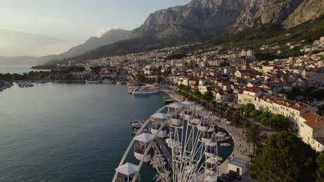 Aerial-Flyover-Of-Ferris-Wheel-And-Harbour-At-Makarska-In-Croatia