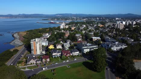 Victoria,-BC,-with-coastal-skyline,-residential-area,-and-greenery,-aerial-view