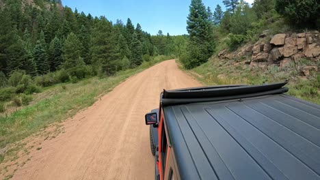 POV---View-of-vehicle-rooftop-driving-through-Phantom-Canyon-in-Rocky-Mountains