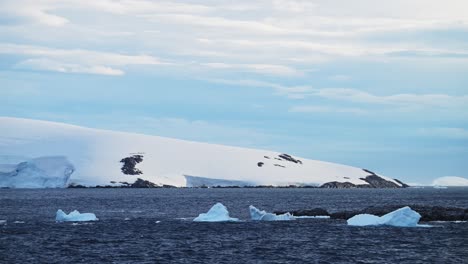 Sun-Melting-Ice-in-Global-Warming,-Antarctica-Coast-in-Winter,-Ocean-with-Dramatic-Clouds-and-Sky,-Amazing-Scenery-on-Coast,-Sunset-Coastal-Scenery-in-Icy-Snowy-Scene