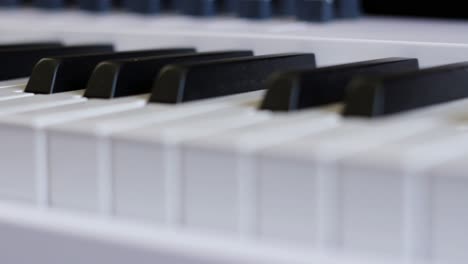 Side-Angle-View-of-Piano-Keys-Waiting-to-be-Played-by-Pianist-Composer-4K