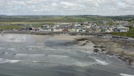 Aerial-along-Lahinch-beach,-popular-surf-spot-in-County-Clare,-Ireland