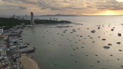 Panoramic-sunset-beach-at-Pattaya-Thailand-travel-resorts-boats-float-Aerial-Sky-background,-Drone-landscape