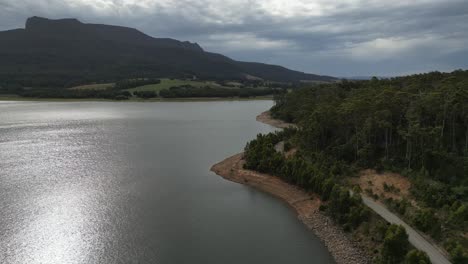 Rural-road-along-Huntsman-Lake,-Tasmania-in-Australia