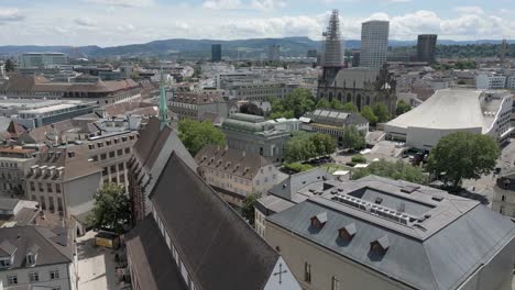 4K-Drone-Video-of-Trains,-Churches-and-Historic-Buildings-of-the-Skyline-of-Basel,-Switzerland