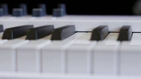 Smooth-Camera-Dolly-Close-Up-Along-White-Piano-Keys