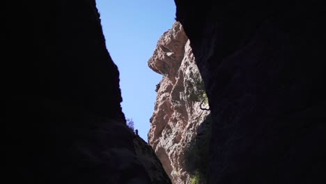 Looking-through-steep-rocky-hills-on-a-sunlit-cliff