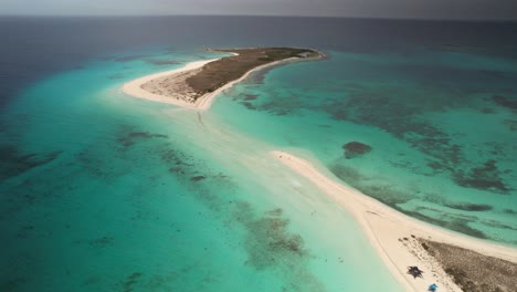 A-serene-island-surrounded-by-turquoise-waters-and-a-white-sand-beach,-aerial-view