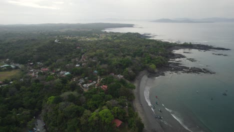 Aerial-view-of-Santa-Catalina-coastline-in-Panama,-showcasing-the-picturesque-village-buildings-and-lush-greenery-along-the-shoreline