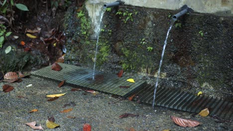 Piping-drains-rain-water-from-behind-wall