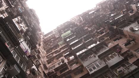 Down-Up-Orbital-View-Of-Dense-Old-Residential-Apartment-Buildings-In-Hong-Kong-City,-Urban-Dwelling