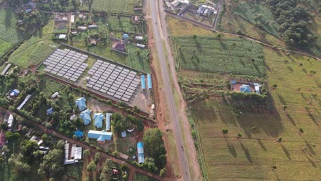 Solar-panel-farm-and-contemporary-houses-on-modern-plantations-in-Southern-Kenya,-aerial-view