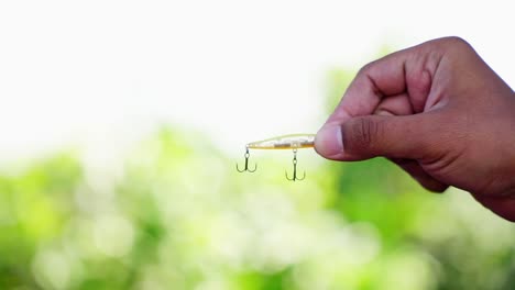 Treble-hook-yellow-slip-minnow-fishing-lure-on-blur-background