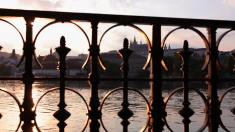 Dolly-past-iron-fence-and-Prague-Castle-and-Vltava-river_Czech-Republic