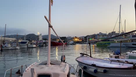 Boats-docked-in-a-tranquil-harbor-at-sunset-in-Mallorca,-Spain