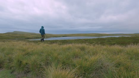 Alone-hiking-in-England-countryside,-North-Yorkshire-Whernside-tarn