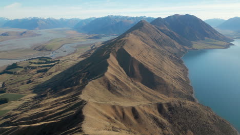 New-Zealand-Mountain-Range-And-Beautiful-Blue-Lake-Coleridge-In-Canterbury-South-Island-Pan-Up-4K