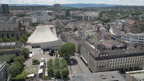 4K-Drone-Video-of-Trains-and-Basel,-Switzerland-with-Historic-Buildings,-Gothic-Churches,-and-Modern-Opera-House