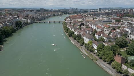 4K-Drone-Video-of-River-Ferries-near-Wettsteinbrücke-Bridge-over-the-Rhine-River-in-Basel,-Switzerland