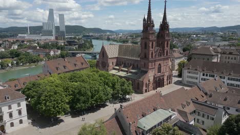 Vídeo-De-Dron-En-4K-De-Una-Iglesia-Gótica-Y-Un-Puente-A-Lo-Largo-Del-Río-Rin-En-Basilea,-Suiza