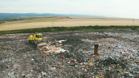 High-quality-footage-of-landfill-with-geomembrane,-garbage-trucks-and-tractors-processing-and-shredding-waste,-drone-shots,-nature-surrounding-energy-plant-chimneys,-showcasing-environmental-themes