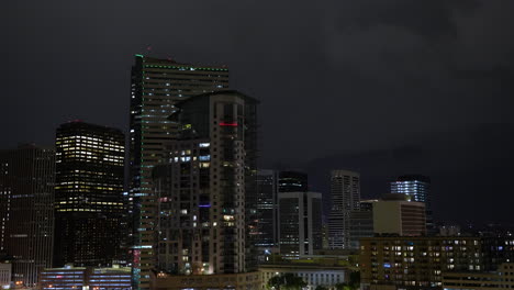 Lightning-in-night-sky-over-city-of-Denver-skyline-and-illuminated-buildings