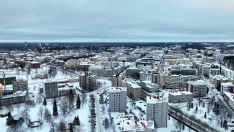 Static-drone-shot-of-downtown-Lahti-city,-cloudy,-winter-evening-in-Finland