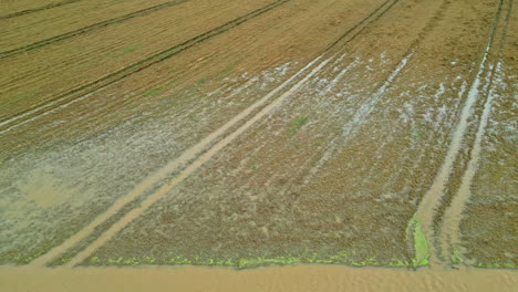 A-waterlogged-field-after-heavy-rainfall,-aerial-view