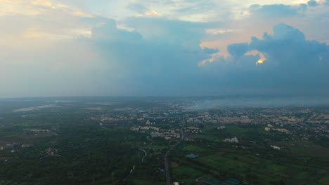 A-sprawling-cityscape-surrounded-by-greenery-at-dawn,-aerial-view,-Incredible-India