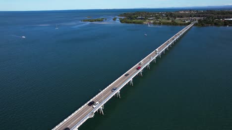 Vehicles-Traveling-In-Bribie-Bridge-In-Queensland,-Australia---Aerial-Drone-Shot