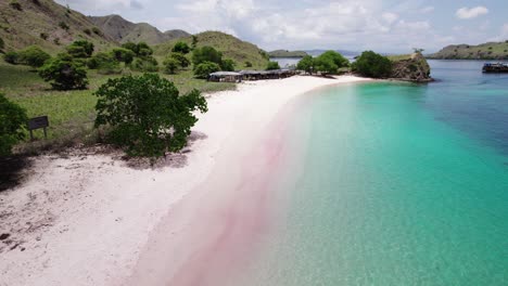 Experience-the-stunning-shores-of-Pink-Beach-in-Komodo-National-Park,-featuring-its-distinctive-pink-sand-and-clear-turquoise-waters-in-a-serene-and-picturesque-setting