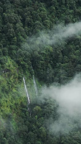 Vertical-Mountains-Waterfall-in-Clouds-with-Beautiful-Green-Forest-of-Trees,-Vertical-Video-for-Social-Media-Instagram-Reels-and-Tiktok-of-Beautiful-Green-Nature-Shot-in-Himalaya-Mountains